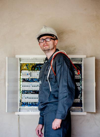 Emergency electrician repairing consumer unit during an urgent callout in Greater Manchester
