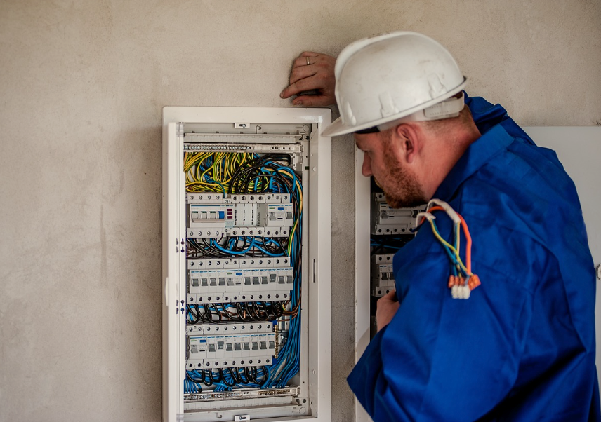 Commercial electrician carrying out electrical installation in an office in Greater Manchester